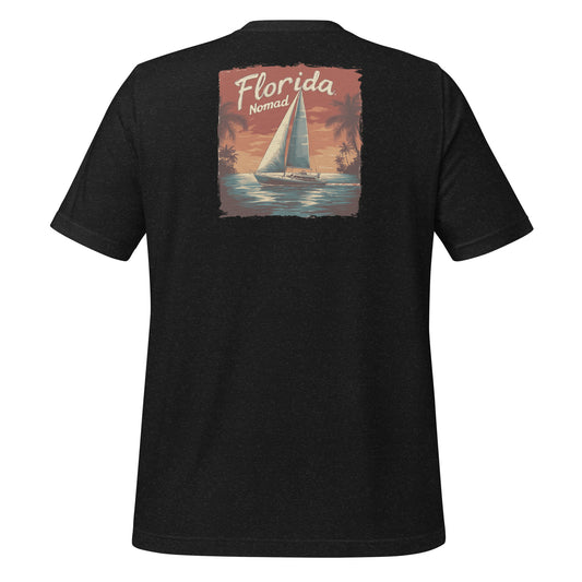 Black Florida Nomad t-shirt with a vintage sailboat design at sunset, reflecting tropical coastal vibes and ocean adventure.