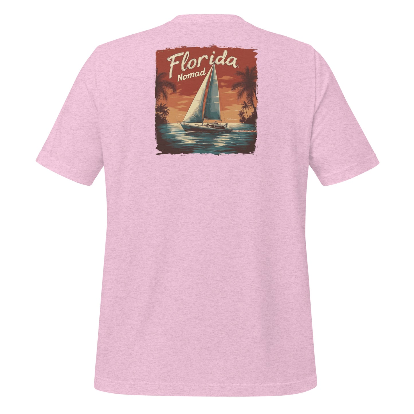 Pink Florida Nomad t-shirt with a vintage sailboat design at sunset, reflecting tropical coastal vibes and ocean adventure.